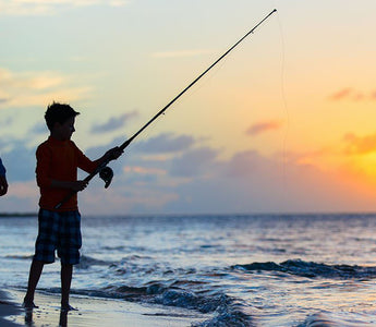 father and son fishing on beach