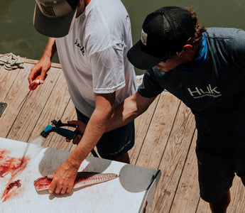 gutting fish on dock