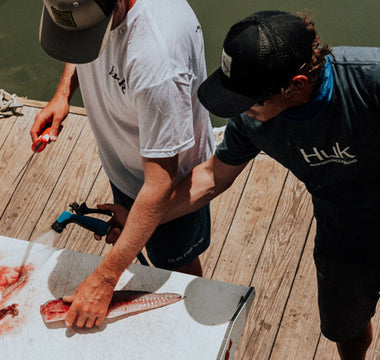 gutting fish on dock